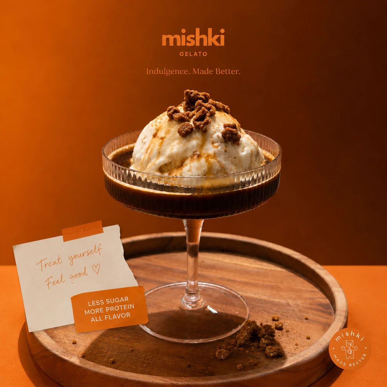 Gelato in a coupe glass topped with crumble, served on a wooden tray